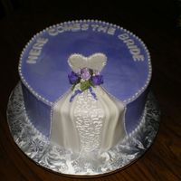 Frontview.jpg Yellow cake w/strawberry filling, whipped icing and fondant accents. Flowers are ribbon roses. Thanks for looking.