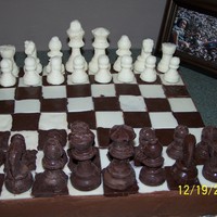Chess Board Cake Awesome Chocolate cake w/Chocolate Buttercream frosting..Chess pieces and Board all made with Chocolate..Made for my sons 29th Birthday......
