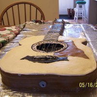 Taylor Guitar Cake Guitar carved to look like my brother-in-laws cake...Special Strawberry Cake covered in Buttercream and accents were mmf..strings were...
