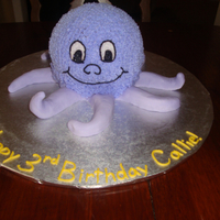 Friendly Octopus Buttercream octopus with fondant Tentacles. It had cupcakes with fondant starfish that went with it.