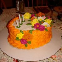 Thanksgiving Holiday Centerpiece Centerpiece made for Thanksgiving Holiday dinner in fall colors. Flowers made with royal icing. Basketweave with buttercream icing.