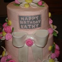 Pink Birthday Cake 8" & 6" buttercream cake. Both layers are vanilla caramel cake with buttercream filling. Fondant/gumpaste bow and button...