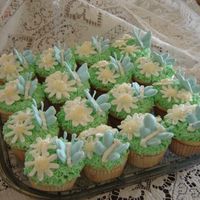 Mother's Day Butterfly Cupcakes White almond sour cream cupcakes with buttercream "grass" and royal icing butterflies and daisies.