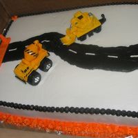 Construction thid is a bc iced cake made for a company that repairs roads