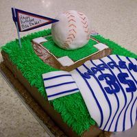 Cubs Baseball Cake decorated for a cubs fan. Jersey made out of fondant, baseball out of rice krispies covered in fondant.