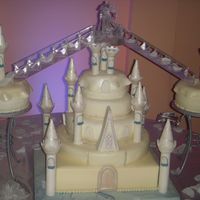 Castle Wedding Cake Cake covered with mm fondant. Turrets and peaks from Wilton's Romantic Castle Cake Set also covered with fondant and decorated with...