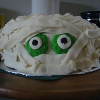 Mummy Cake This is a two layer chocolate cake. The base coat and filling are chocolate and the mummy layer is buttercream. This was for a kids party,...