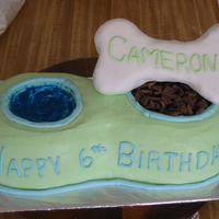 Dog Bowl Regular cake with buttercream frosting. Fondant covered rice crispy treat for the bone, edible glitter for the water, and cut up chocolate...