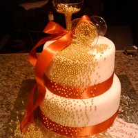 Champange Bubbles MMF, gold dragees, satin ribbon. Thanks soooo much to cownsj for posting her cake, it was great inspiration for this one!