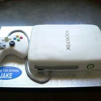 X-Box 360 This was my first x-box cake. Everything is fondant (controller was Rice Krispy treats, console was cake), and everything was covered in...