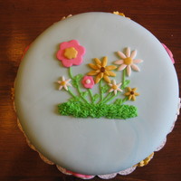 Summer Flower Cake I made this cake for my school's Fun Fair cake walk. The cake is covered and decorated with MMF. I used BC to decorate the border....