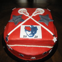 High School Lacrosse Cake marshmallow BC with gum paste decorations, hand painted logo, airbrushed on red to BC and used paper towel to swirl emboss design