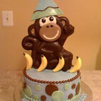 Monkey 10" cake covered in buttercream with fondant circles. Monkey was made with chocolate. Molded him using the Wilton Monkey Pan.