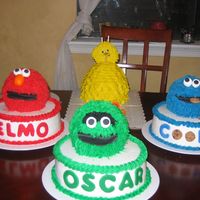 Sesame Street 1St Birthday Elmo, Cookie Monster and Oscar are all made with sports ball pan sitting on a 10"cake. Big bird was made with the wonder mold. Big...