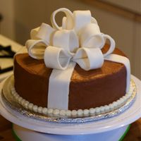 First Fondant Bow 8" round cake covered in chocolate BC. Fondant bow and ribbons. This was my first time doing a fondant loop bow!