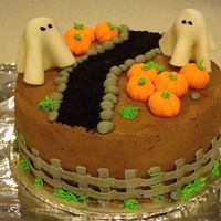 Haunted Pumpkin Patch Birthday cake for my boss (and myself). 9" round vanilla cake covered in BC. Ghosts are fondant covered tootsie roll pops. Path is...