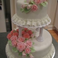 Wilton Course 3 Final Cake Marbled cake covered with fondant, fondant roses, buttercream ruffle border.