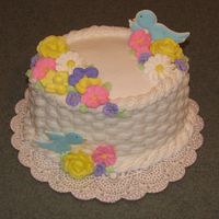 Wilton Course 2 Final Cake Lemon cake with buttercream frosting, royal icing flowers, birds made with color flow.