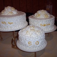 50Th Anniversary Gold Cake the piping on the side is done just free hand and the lil gold balls were each placed with tweezers! the roses are gold tipped by using the...