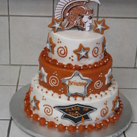 Trojan Graduation Cake This was a three tiered graduation cake. School colors are burnt orange and white and the mascot is a trojan. Stars and graduation cap are...