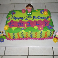 Dora The Explorer Cake This was a 2-layer 9X13 cake. Iced in buttercream. Stars, leaves, and flowers all fondant. Characters are plastic. Got inspiration from a...