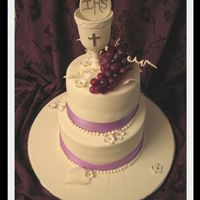 First Holy Communion Cake This was for a little girl whose favorite color was purple. Everything is edible accept for the grapes. Cup is made out of gumpaste. Thank...