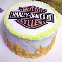 Harley-Davidson Anniversary Cake White chocolate cake with a layer of white chocolate ganache and a layer of raspberry filling. Frosted in buttercream with an edible image...