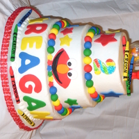 Elmo! Made for my neighbors 2nd birthday. Buttercream with fondant decorations. All edible except the Elmo and Dorothy on top. Vanilla cake with...