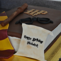 Harry Potter Book Cake Made for my son. Two 9x13" cakes stacked and trimmed slightly. Covered with chocolate fondant and fondant decorations.