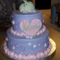 The Princess And The Frog 9" and 6" stacked cakes. Buttercream icing, royal icing flowers, fondant heart, dusted with pearl dust, purchased cake topper....