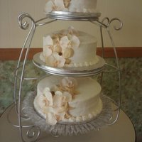 Beach Themed Wedding Cake Completely buttercream with silk orchads and chocolate shells.