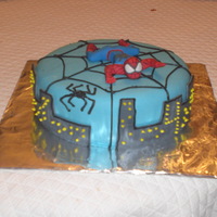 Spiderman chocolate cake with butterscotch filling. 4th birthday. Fondant covered, spiderpan made of gumpaste and web outlined in buttercream icing...