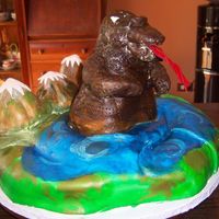 Godzilla This is a photo of a Godzilla cake for a 50th birthday. The cake was sculpted out of chocolate cake, frosted and covered with fondant. The...