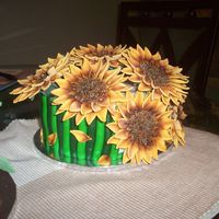 100_1998.jpg This is a yellow cake with buttercream icing, decorated with mmf and the sunflowers have 32 petals each this is a gift for my step mom i...