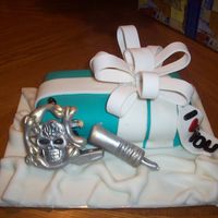 100_2034.jpg i made this for my hubby he is a tattoo artists and he love it the little cake is covered with mmf and the tattoo machine is made from...