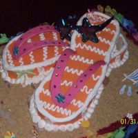 Beachy Fun! Flip Flop cake covered in BC. Gumpaste thong part with rhinestone details. Graham cracker crumb "sand" and scrapbooking stickers...