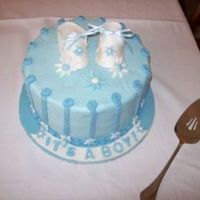 Baby Booties The cake is all buttercream except for the booties and daisies.This was my first time making booties. Thank you so much for the template.