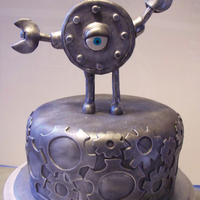 Steampunk Cake With Clank This cake is a dutch chocolate cake, filled with raspberry and covered in chocolate fondant. The figure on top, Clank, is from a comic...