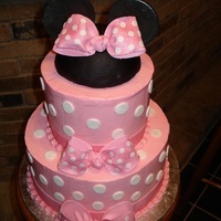 Minnie Mouse Cake Two tiers of vanilla bean cake with layers of vanilla bavarian cream and vanilla italian meringue buttercream