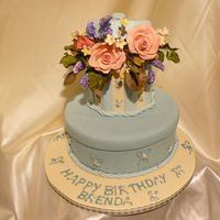 Brend's Birthday Fondant covered. Gumpaste flower's. I need to work on piping.