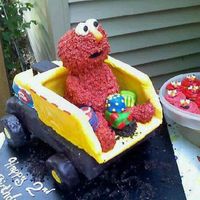 Elmo In A Tonka Truck I made this for a little guy who likes trucks & Elmo... so I figured I would just put Elmo in a tonka truck :) The cake is dark...