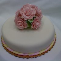 Fondant Cake With Gumpaste Roses genoise cake, with swiss buttercream. covered in fondant. i used an extruder and pink and yellow fondant to make the rope. gumpaste roses...