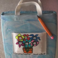 Tote Bag W/ Kid Logo This is a 1-layer cake covered in marbled fondant, w/ fondant accessories (pencil, tote bag pocket). Pocket is personalized w/ colored logo...