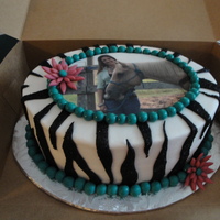Brecca's Zebra Print 2-layer oval cake iced with buttercream, with an edible image on it and fondant zebra stripes and fondant "balls". The birthday...