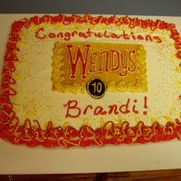 Wendy's Anniversary White cake with orange buttercream. This was for an employee's 10th anniversary with Wendy's. The center is made to look like a...