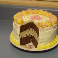 Ice Cream Cake With Flowers This is my first ice cream cake. It has two layers of chocolate cake, and the middle is cookies n' cream ice cream. It's iced in...