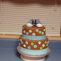 Baby Sneakers Two tiered chocolate lover's cake with chocolate buttercream. The dots and ribbon are fondant, and I just bought a real pair of shoes...
