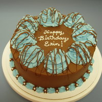 Simple Design Chocolate cake with chocolate icing with buttercream and pearl sprinkles.