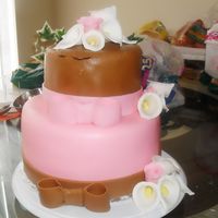 Birthday Cake Chocolate cake with vanilla icing. Brown and pink fondant with gum paste lilies and roses. Didn't turn out how I planned but still...