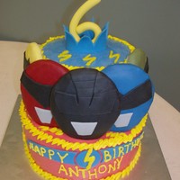 Power Rangers Cake German chocolate 8 and white 6-inch tiers iced in buttercream. "6" made of fondant and helmets made from cookies & fondant.
